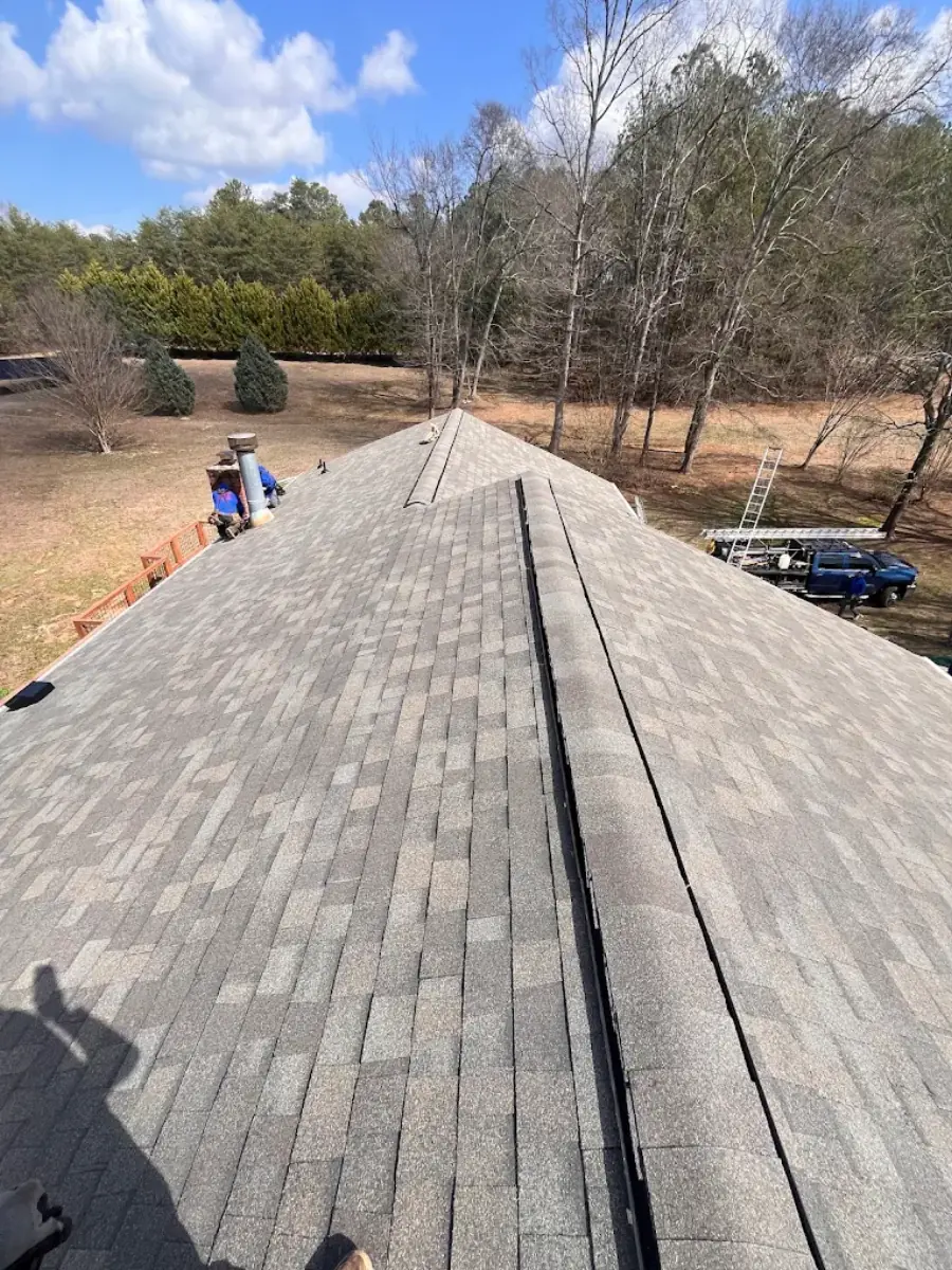 Aerial view of crew installing a new asphalt shingle roof