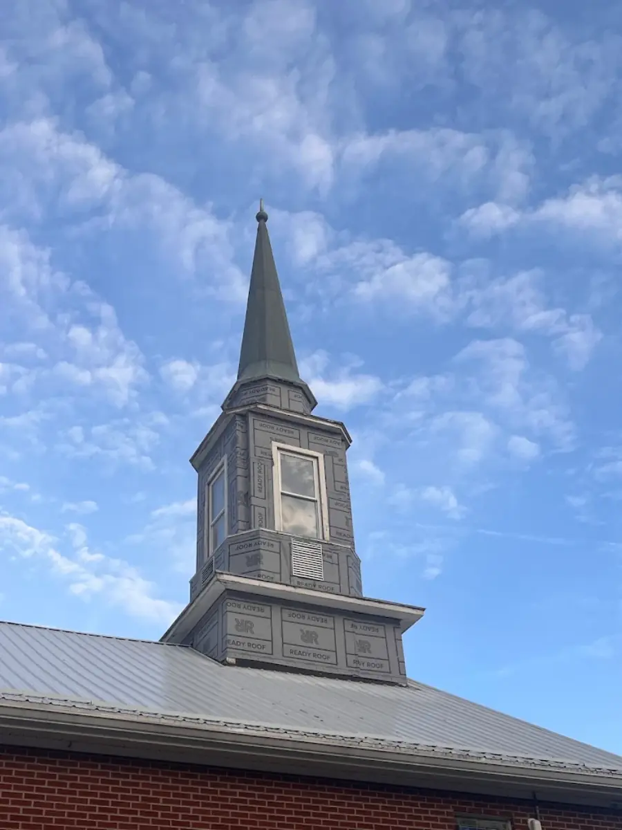 Church steeple wrapped in roofing underlayment during a re-roof project